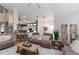 Spacious living room featuring a cozy reclining sofa, and seamlessly connected to the kitchen at 9980 Sago Point Dr, Seminole, FL 33777