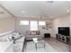 Cozy living room with neutral colors, plush sofas, and a view of the surrounding landscape at 9980 Sago Point Dr, Seminole, FL 33777