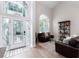 Bright living room boasts decorative front door, soaring ceilings, and eye-catching decor at 9980 Sago Point Dr, Seminole, FL 33777