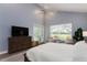 Beautiful main bedroom features a ceiling fan, a large window, a sitting area, and plenty of natural light at 9980 Sago Point Dr, Seminole, FL 33777
