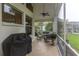 Relaxing screened-in patio with comfortable seating, ceiling fan, and view of the pool at 9980 Sago Point Dr, Seminole, FL 33777
