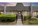 Charming townhouse with a unique roofline and tidy landscaping at dusk at 1002 Cordova Grn, Seminole, FL 33777