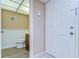 Bathroom view with wooden vanity, and wooden-look floors, and a partial view of the entry door at 10190 Imperial Point W Dr # 8, Largo, FL 33774