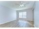 Bedroom featuring new vinyl floors, ceiling fan, and a large window at 10190 Imperial Point W Dr # 8, Largo, FL 33774