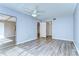 Bedroom featuring new vinyl floors, ceiling fan, and access to bathroom at 10190 Imperial Point W Dr # 8, Largo, FL 33774