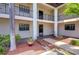 Charming courtyard with manicured landscaping, decorative flower pot, and covered walkways to units, offering a serene outdoor space at 10190 Imperial Point W Dr # 8, Largo, FL 33774