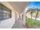 Exterior of the condos featuring palm trees and a covered walkway with a tile floor at 10190 Imperial Point W Dr # 8, Largo, FL 33774