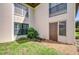 An exterior view of the condos features a front entrance, shutters, and green grass at 10190 Imperial Point W Dr # 8, Largo, FL 33774
