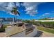 Outdoor grilling area featuring built-in gas grills, a granite countertop, and scenic waterfront views at 10190 Imperial Point W Dr # 8, Largo, FL 33774