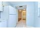 Hallway view with tile flooring, leading to another room and a partial view of the kitchen at 10190 Imperial Point W Dr # 8, Largo, FL 33774