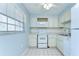Bright kitchen features white appliances, tiled floors, and ample cabinet space at 10190 Imperial Point W Dr # 8, Largo, FL 33774
