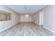 Spacious living room features new vinyl floors, modern lighting, and neutral walls at 10190 Imperial Point W Dr # 8, Largo, FL 33774