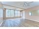 Bright living room with wood-look flooring, ceiling fans, and lots of natural light at 10190 Imperial Point W Dr # 8, Largo, FL 33774