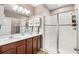 Bright bathroom featuring a glass enclosed shower, double vanity, and tile floors at 10196 Cross Timber Ter, Land O Lakes, FL 34638