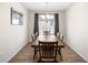 Dining room with wood-look tile flooring, chandelier and view of manicured backyard at 10196 Cross Timber Ter, Land O Lakes, FL 34638