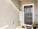 Close up of front door with welcome decorations and sidelight at 10196 Cross Timber Ter, Land O Lakes, FL 34638