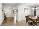 Open concept home showcasing wood-look tile floors and neutral paint from foyer to dining area at 10196 Cross Timber Ter, Land O Lakes, FL 34638