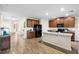 Well-lit kitchen featuring wood-look tile floors, granite countertops, stainless steel appliances, and an eat-in island at 10196 Cross Timber Ter, Land O Lakes, FL 34638