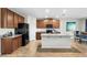 Island kitchen boasts granite countertops, modern appliances and barstool seating at 10196 Cross Timber Ter, Land O Lakes, FL 34638