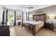 Spacious main bedroom featuring tile floors, a ceiling fan, and large windows with dark gray curtains at 10196 Cross Timber Ter, Land O Lakes, FL 34638