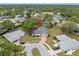 Aerial view of a single-story home situated on a corner lot in a neighborhood with mature trees at 112 Rosewood Ct, Palm Harbor, FL 34685