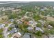 Aerial view of a single-story home situated on a corner lot in a neighborhood with mature trees at 112 Rosewood Ct, Palm Harbor, FL 34685