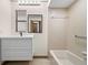 Well-lit bathroom with a modern vanity, decorative mirror, and a shower-tub combination at 112 Rosewood Ct, Palm Harbor, FL 34685