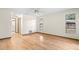 Bright bedroom featuring hardwood floors and two windows allowing natural light at 112 Rosewood Ct, Palm Harbor, FL 34685