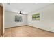 Bedroom with natural light, ceiling fan, and wood-look laminate flooring at 112 Rosewood Ct, Palm Harbor, FL 34685