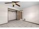Bedroom with tile floor, a ceiling fan and open closet at 112 Rosewood Ct, Palm Harbor, FL 34685