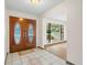 Inviting foyer with decorative double doors and tile flooring, leading to a bright living area at 112 Rosewood Ct, Palm Harbor, FL 34685