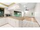 Kitchen with breakfast bar and open access to the living room and pool beyond at 112 Rosewood Ct, Palm Harbor, FL 34685