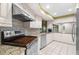 Well-equipped kitchen featuring stainless steel appliances, granite countertops, and mosaic backsplash at 112 Rosewood Ct, Palm Harbor, FL 34685