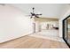 Living room showcases hardwood floors, kitchen access, and a sliding glass door at 112 Rosewood Ct, Palm Harbor, FL 34685