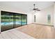 Open living area with hardwood flooring and access to the pool at 112 Rosewood Ct, Palm Harbor, FL 34685