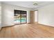 Bright main bedroom with wood floors and sliding glass doors leading to the pool area at 112 Rosewood Ct, Palm Harbor, FL 34685