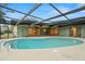 A beautiful pool is surrounded by a screened enclosure, providing a private and comfortable experience at 112 Rosewood Ct, Palm Harbor, FL 34685