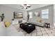 Bright living room with white sofas, ceiling fan, decorative rug, and neutral decor at 11412 Freshwater Ridge Dr, Riverview, FL 33569
