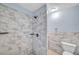 Bathroom features updated marble shower and matching half wall at 1225 26Th N St, St Petersburg, FL 33713