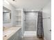 Updated bathroom featuring a gray vanity, tiled shower with a shower curtain, and built in shelves at 1225 26Th N St, St Petersburg, FL 33713