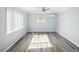 A bright, empty bedroom with light blue walls, wood floors, and a ceiling fan at 1225 26Th N St, St Petersburg, FL 33713