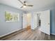 Bright bedroom featuring a ceiling fan, light blue walls, wood floor and a window with natural light at 1225 26Th N St, St Petersburg, FL 33713