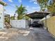 Carport parking area with paved surface, sun protection, and landscaped surroundings at 1225 26Th N St, St Petersburg, FL 33713
