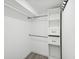 Walk-in closet with gray wood-look floors and closet organization system at 1225 26Th N St, St Petersburg, FL 33713