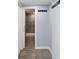 Hallway features wood-look flooring, coat hooks, and a bathroom with tiled shower can be seen through the doorway at 1225 26Th N St, St Petersburg, FL 33713