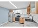 Stylish kitchen with white and wood cabinets, stainless steel appliances, and modern fixtures at 1225 26Th N St, St Petersburg, FL 33713