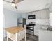 Modern kitchen features updated appliances, countertops, and cabinets with an island at 1225 26Th N St, St Petersburg, FL 33713