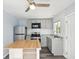 Bright kitchen with gray cabinets, stainless steel appliances, butcher block island and subway tile backsplash at 1225 26Th N St, St Petersburg, FL 33713