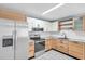 Bright kitchen featuring white and wood cabinets, stainless steel appliances, and tile floors at 1225 26Th N St, St Petersburg, FL 33713