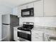 Updated kitchen with stainless steel appliances, modern backsplash and light granite countertops at 1225 26Th N St, St Petersburg, FL 33713